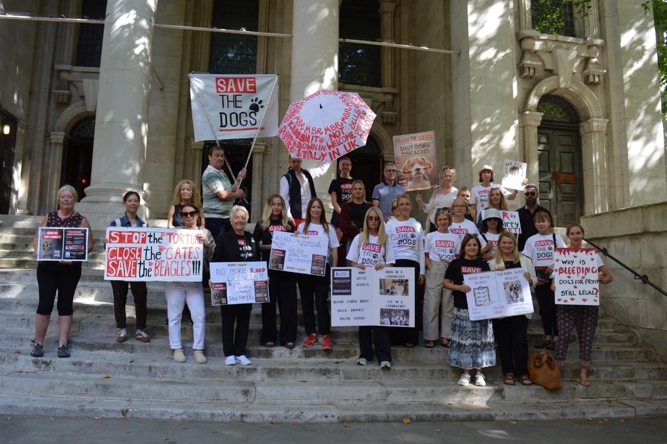 Group of campaigners with banners as they prepare to demonstrate outside the home office.