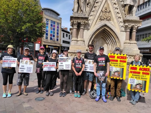 Group of campaigners smiling with banners.